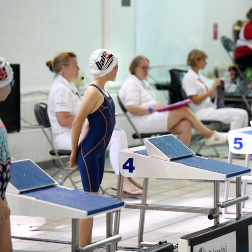 Swimmer doing backstroke in swimming pool